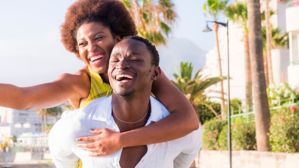 A man carrying a woman on his back, symbolizing the support and strength found in therapy.